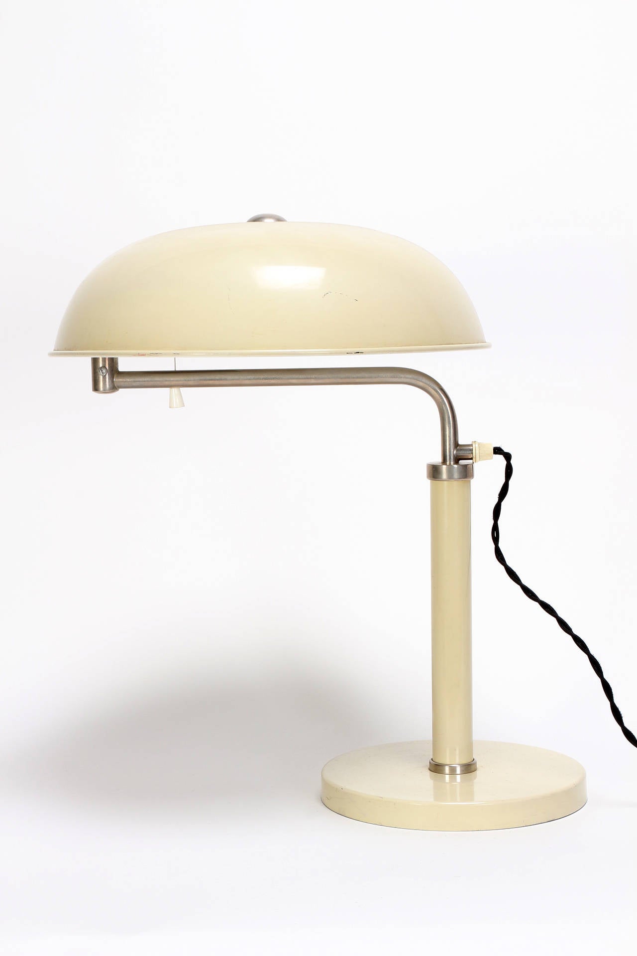 Classical Bauhaus desk lamp by Alfred Mueller for AMBA, Switzerland, 1930s. The creme-white lacquered lampshade can be brought in various positions all around, height adjustable up to 63cm.