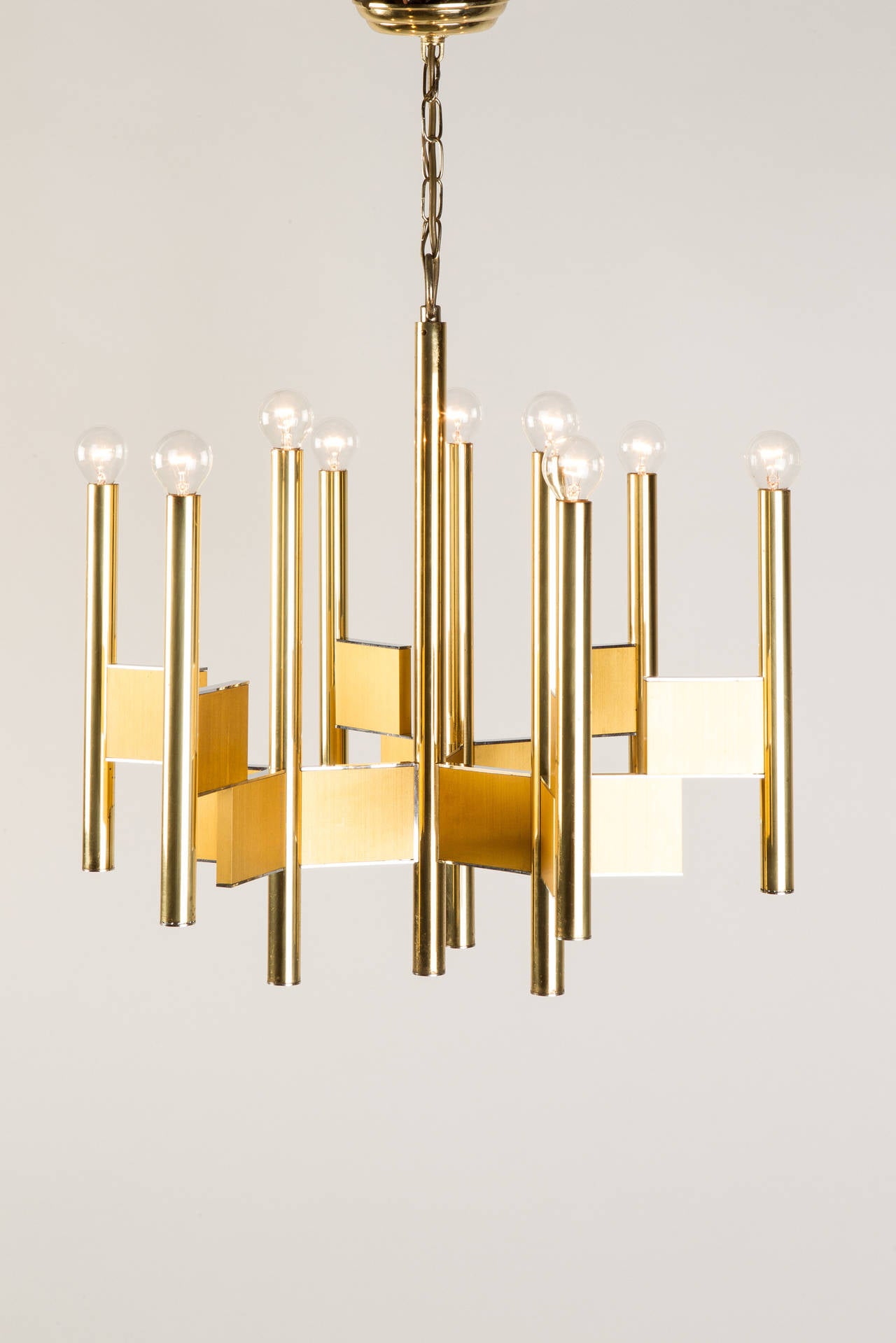 Italian brass chandelier by Gaetano Sciolari, made in Italy in the 1970s by Sciolari. Very sculptural form, the brass plates have chromed edges