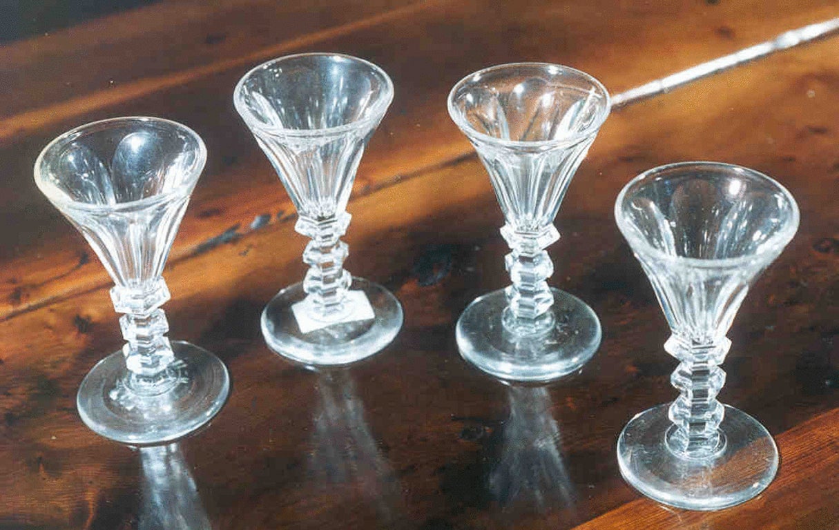 A set of four early 19th century Sherry glasses, the tapered bowls with flat flutes raised on hexagonal stems.