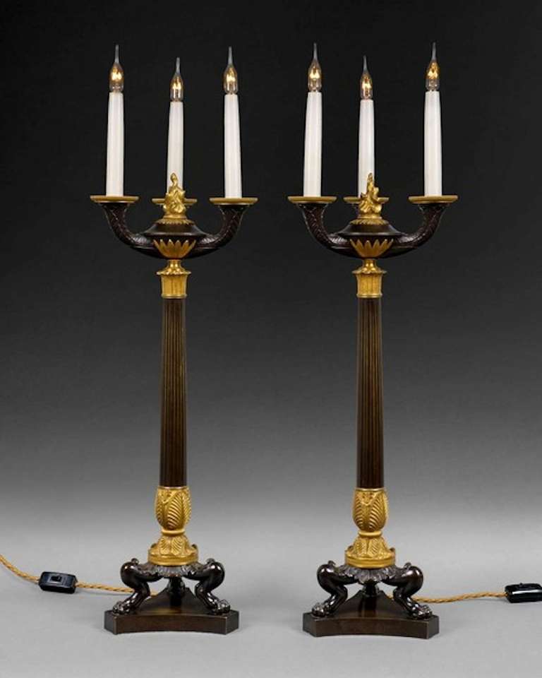 An important pair of Regency period bronze and ormolu three-light candelabra, now wired for electric lamps.