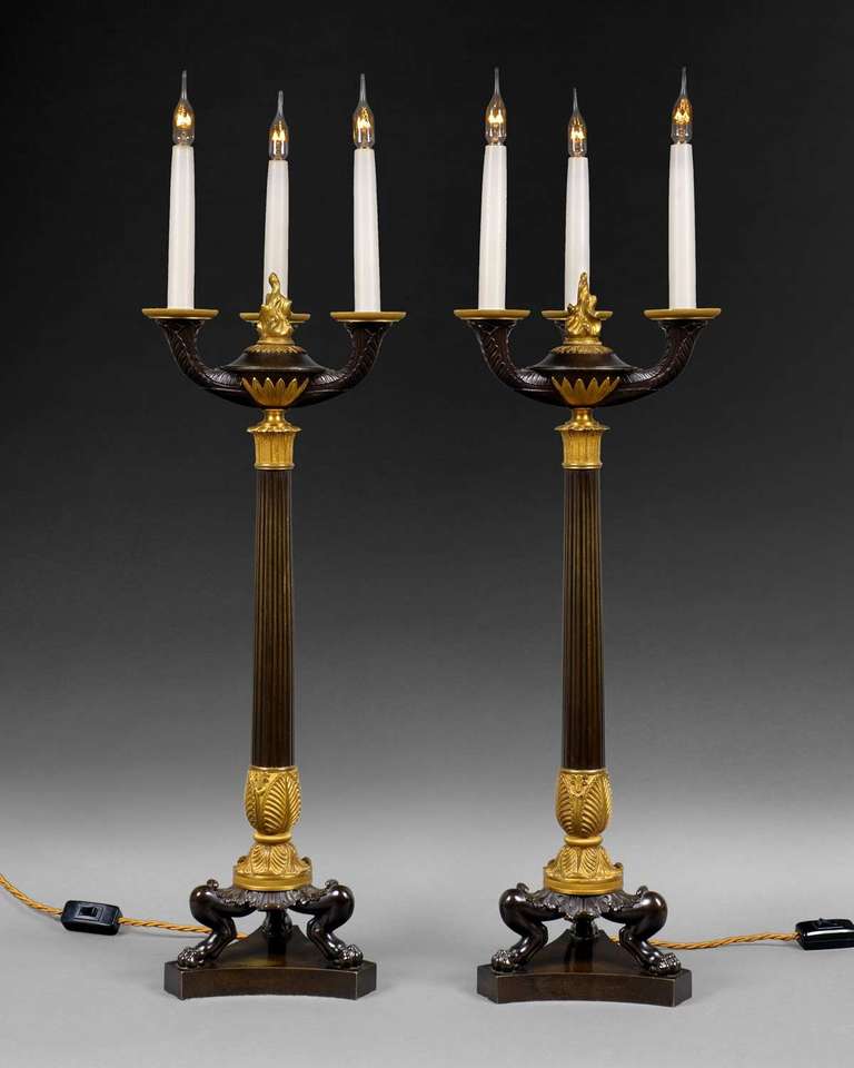 An important pair of Regency period bronze and ormolu three light candelabra, now wired for electric lamps.