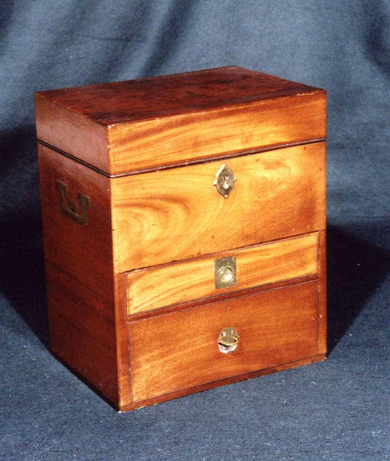 A very good early 19th century fitted mahogany military apothecary’s box, the hinged lid opening to a full set of stoppered bottles above two drawers with a range of fitments, compartments etc. This well fitted box comes with a hand written book