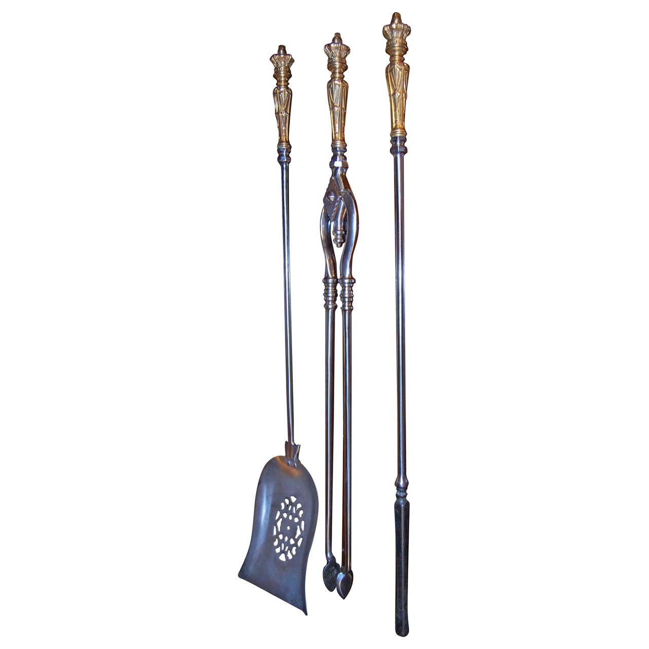 A set of three mid-19th century brass and steel fire irons comprising a shovel, pair of tongs and poker all surmounted with brass handles decorated with Crown finials.