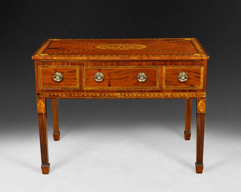 A truly rare and magnificent George III Period mahogany and marquetry inlaid dressing table, the elaborately inlaid flame mahogany rectangular top with cross banded edge above three drawers, the centre drawer fitted for writing and with a baize