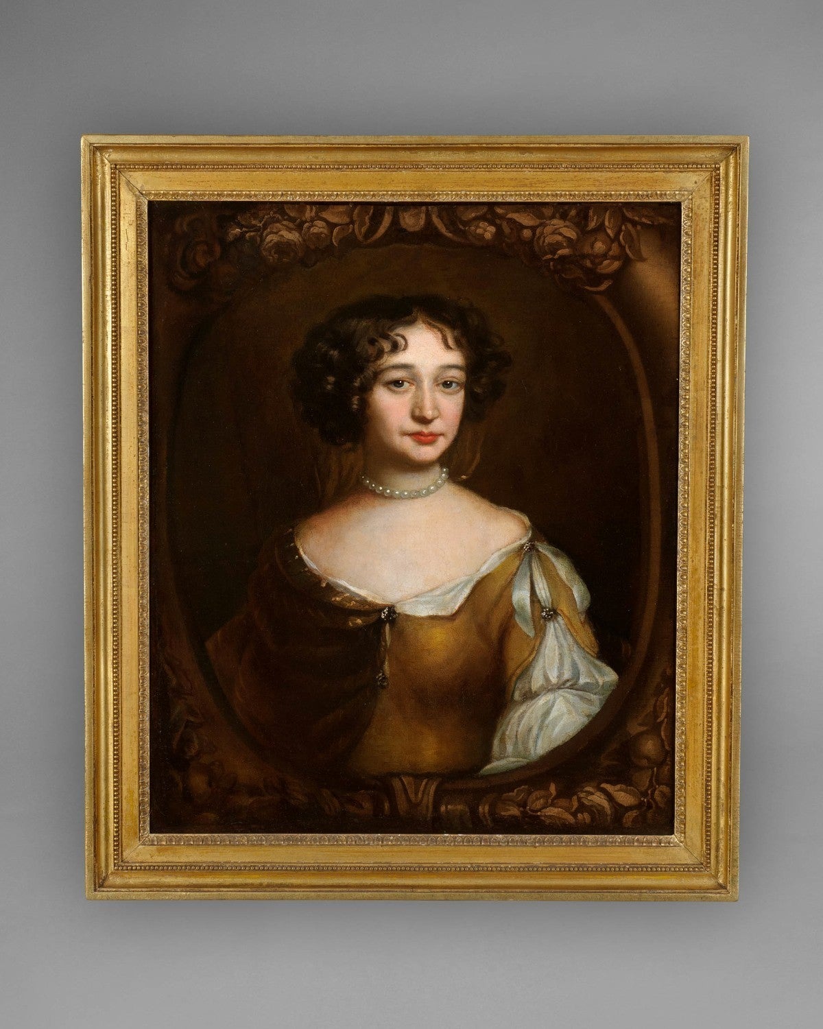 A very good late 17th-early 18th century oil on canvas portrait of a lady, believed to be the sister of “Lady Blake” (See 399S).The style and composition of this portrait is strikingly similar to many of those painted by Sir Peter Lely, the Court