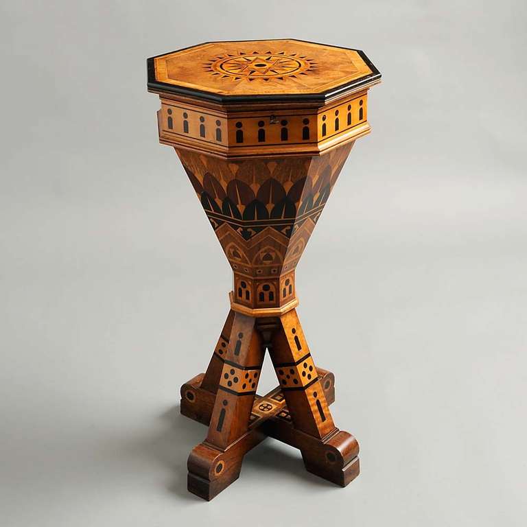An octagonal mid-19th century work table profusely inlaid with walnut, ebony, satinwood and oak in a geometric pattern.
English, attributed to Charles Bevan. circa 1870

Charles Bevan was born in the late 1820s and started gaining recognition for