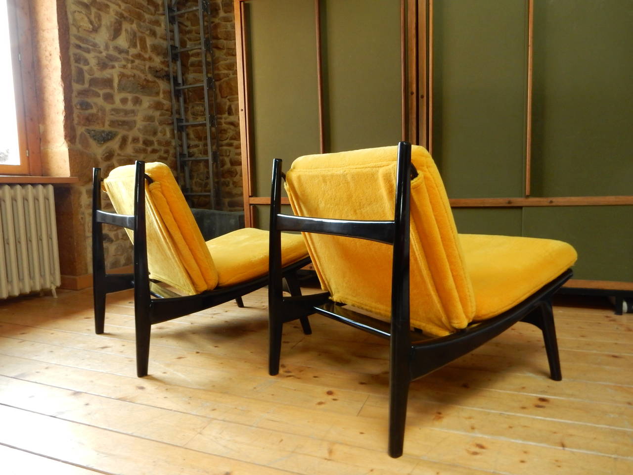 A beautiful pair of Joseph Andre Motte edited by Steiner in 1960-1965 with a new yellow upholstery, structure made of black lacquered wood in perfect condition.