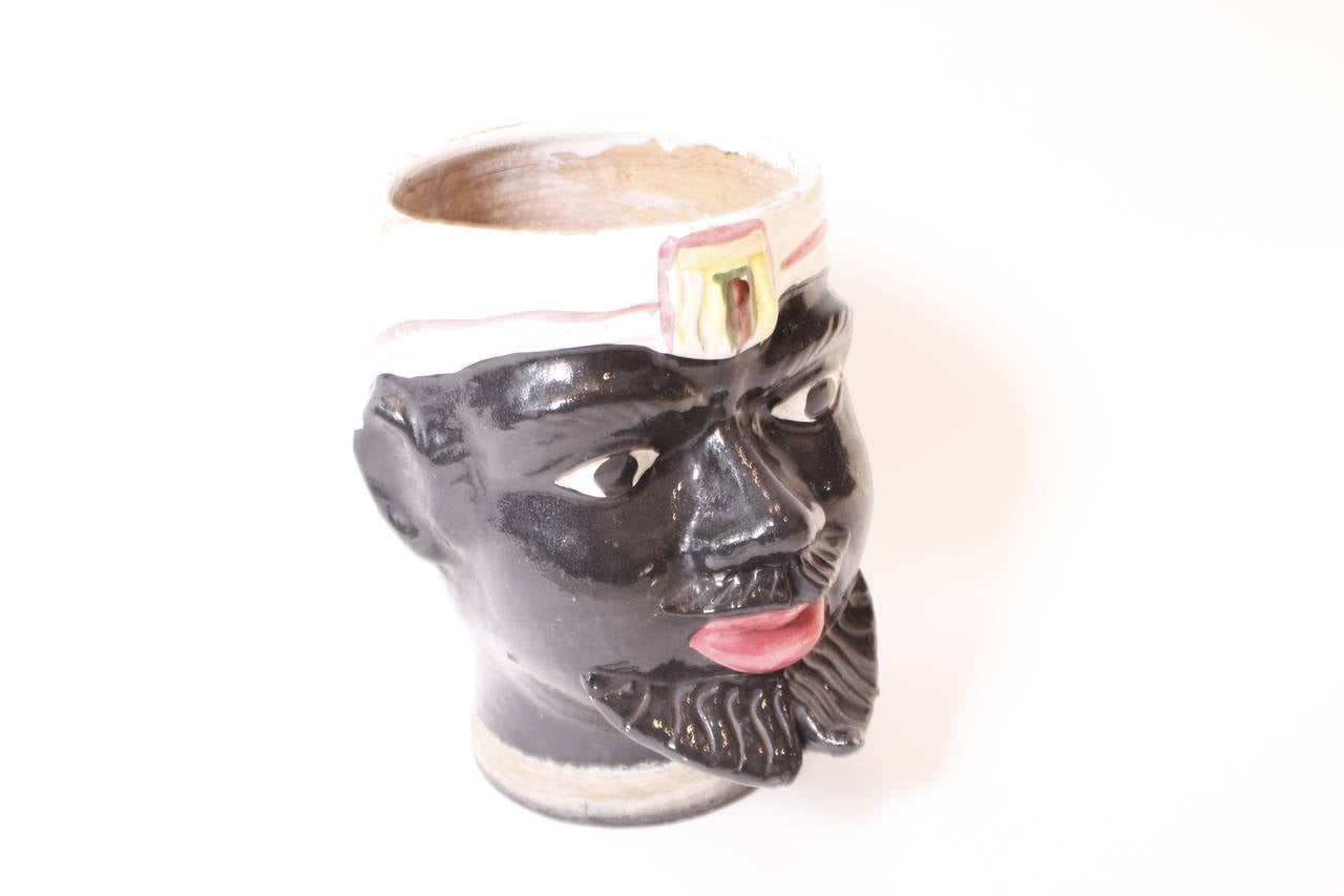 A 1950's Italian glazed Blackamoor planter in terracotta.
In the form of a blackamoor mans  head with hand painted headscarf