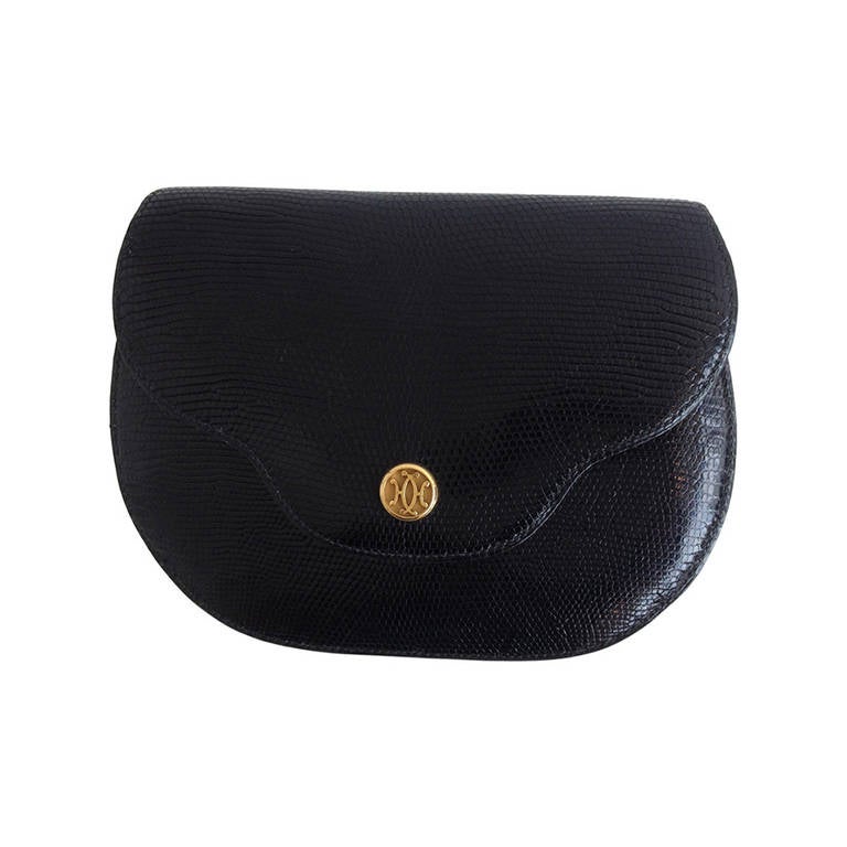 This little vintage purse packs a whole lot of fabulous into a small piece!  The glossy black reptile skin is elegant with a small gold clasp on the outside featuring two interlocking H's.  The interior is lined in exquisite, soft black leather. 