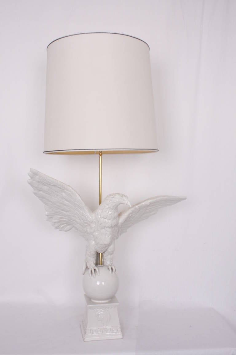 A large unusual lamp,ceramic and brass shade holder  in shape as an eagle with roman design on the base, 1970s Italian.