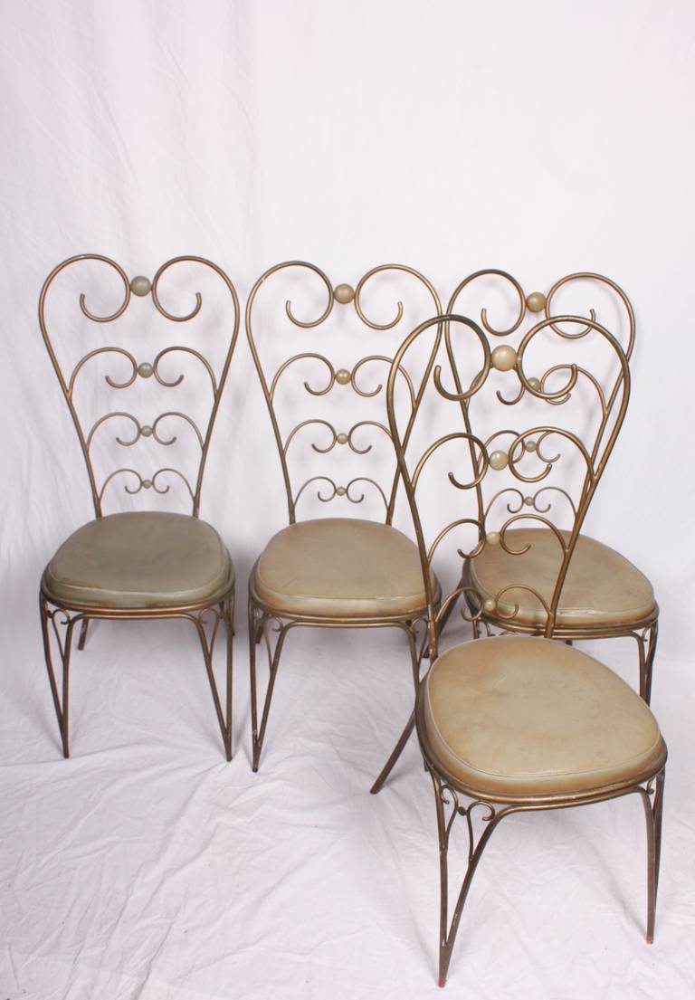 A set of four metal chairs 1950's Italian with leather insets and seats