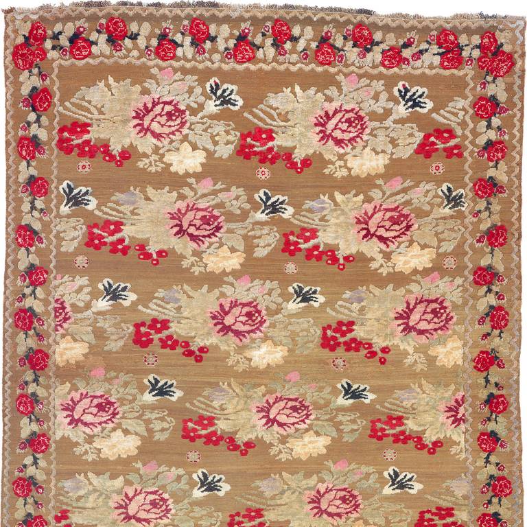 Ukraine, circa 1880
Pile bouquets scattered on the field within a pile rose blossom border, all on camel flat-woven (soumak) ground.
handwoven
