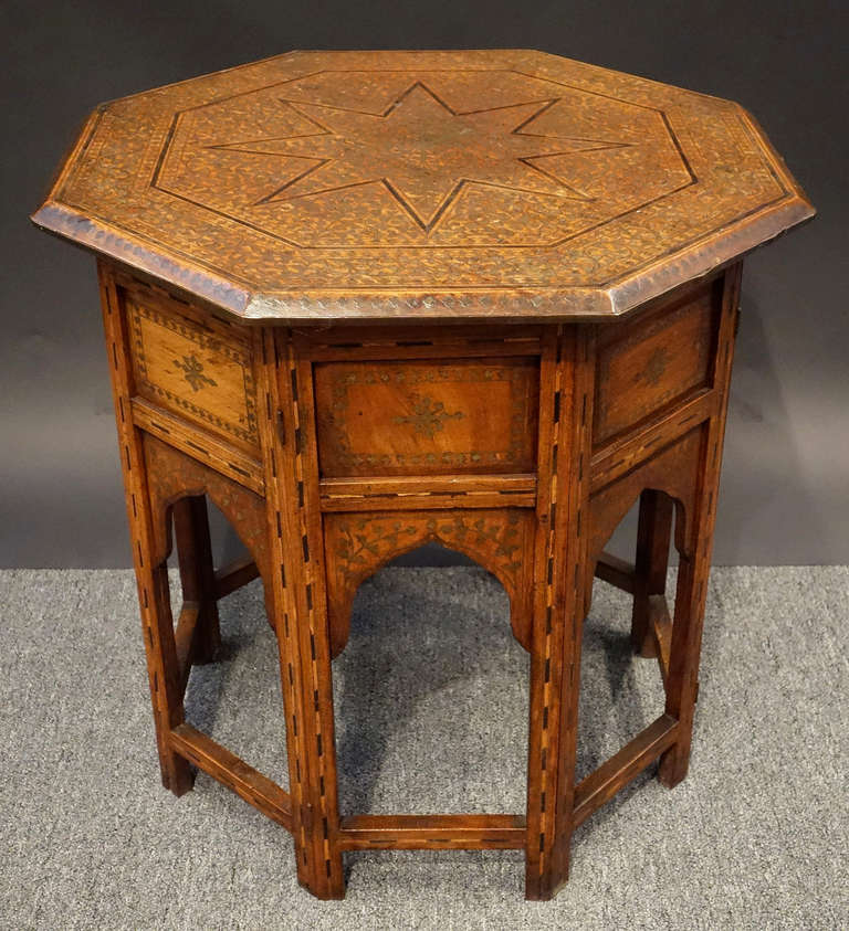 19th century Moorish table with steel and ebony inlay.  Larger than most tables of this type, the beautiful workmanship of intricate inlay is amazing.  Normally this type of table is inlaid with carved bone however here the bone inlay has been