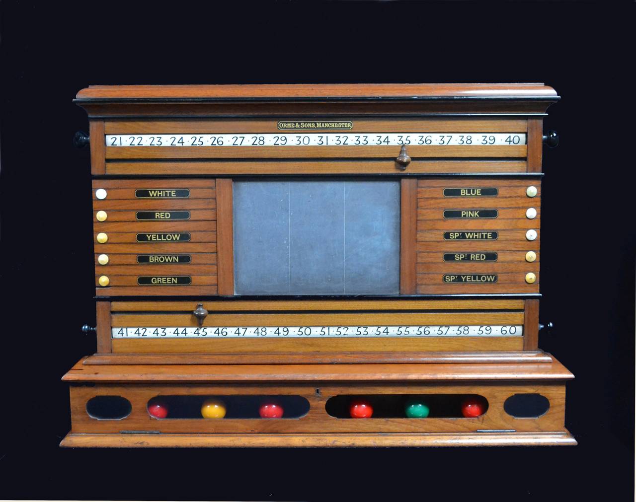 A wall mounted antique billiard snooker, pool scoring cabinet by Orme & Sons of Manchester, circa 1880, hand-painted revolving ratchets and lettered sliding panels with a central slate panel, all mounted on a rectangular ball storage box with glazed