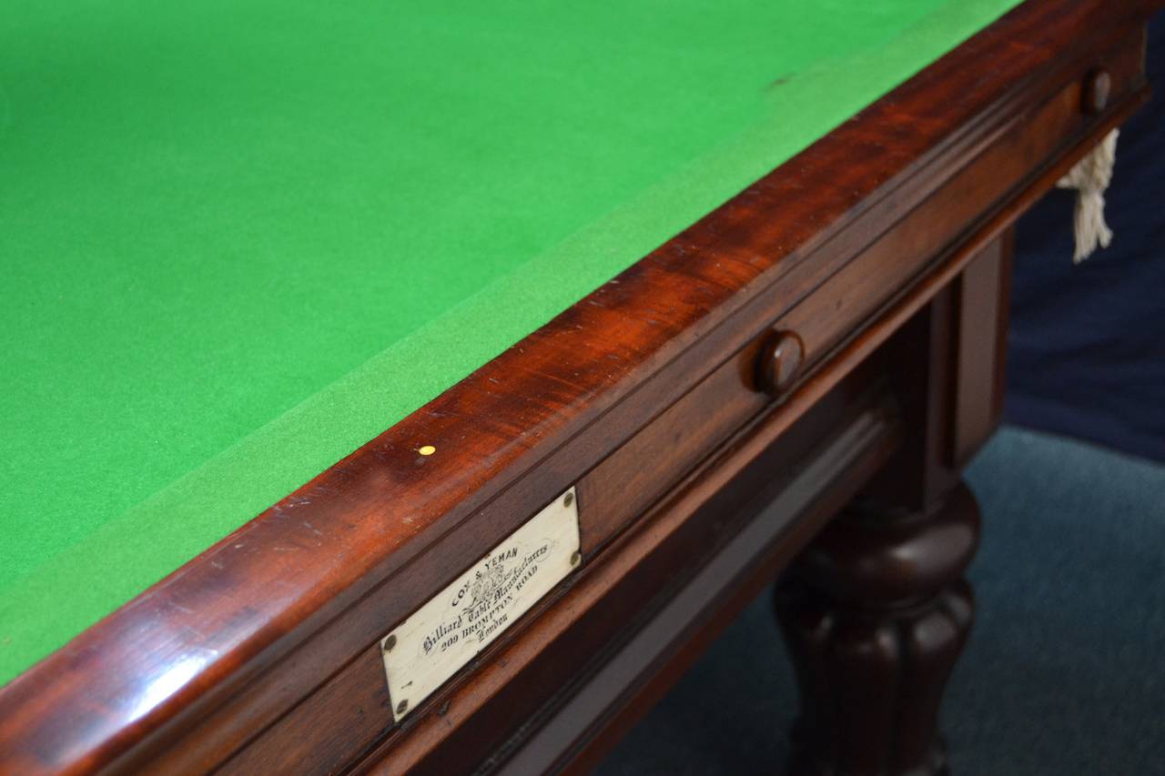 A mahogany framed Billiard- Snooker table (3/4 sized) circa 1870 by Cox & Yeman of London, standing on six sturdy gadrooned legs with applied bosses to the cushion friezes.