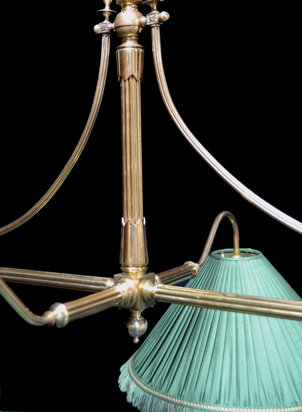 A brass framed Antique Billiard or Snooker table light with restrained decoration, the curved arms support six silk shades,the central column with applied coronet moldings and decorative finials, flanked by two reeded support braces each fitted with