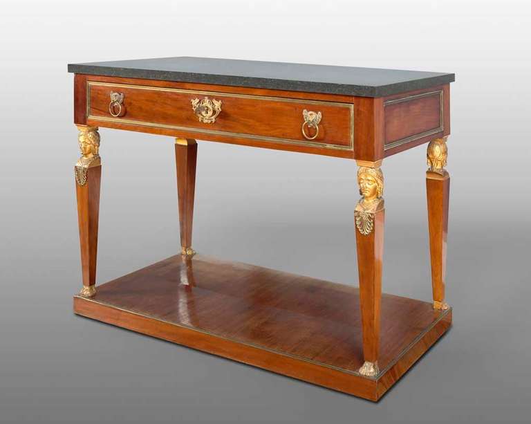 Central Table (c. 1820) 
Spain, Fernando VII Period (1813 - 1833) 
Carved and gilt wood, with Cuban mahogany overlays and gilt bronzes. 
The top is made in Porfido black marble. 
Measures: 81 x 106 x 54 cm. 

This magnificent rectangular table