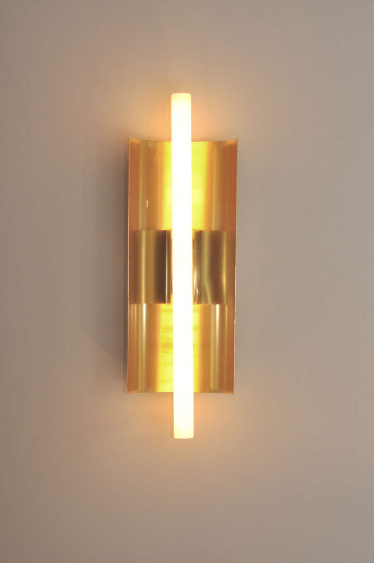 Pair of wall lights made of a curved sheet of anodized aluminum that accepts a light bulb. Issued by Candle.

Provenance: Hotel Parco dei Principi, Rome.