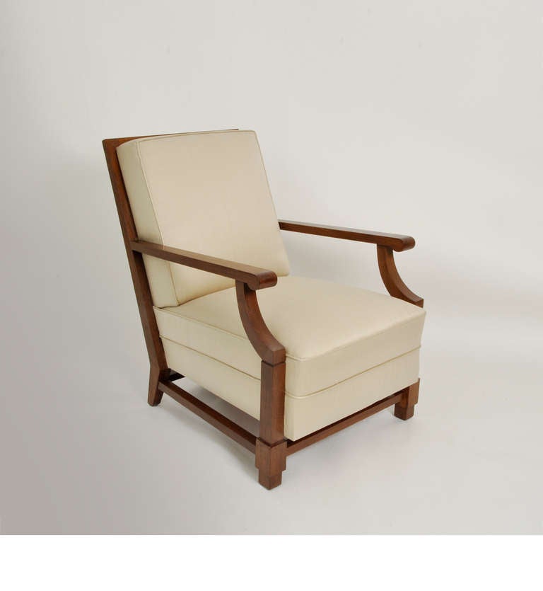Pair of neoclassical solid oak armchairs; armrests end in a crock. Seat and back covered with satin.