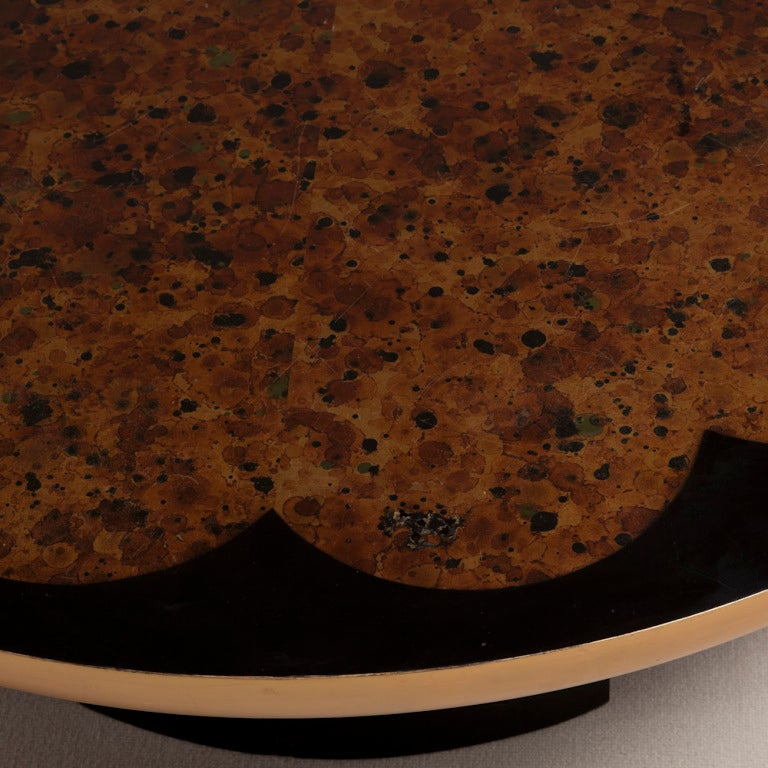 'Lotus' circular coffee table with ebonised floral framing an oil spot finish designed by Theodore Muller and Elizabeth Barringer for Kittinger, Germany circa 1955. The top swivels on an Asian Modern inspired ebonised base.

The Kittinger