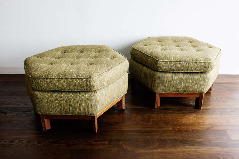 The ottomans were designed in 1955 and manufactured by Heritage Henredon, model no. 1583. The two pieces are in very good condition, newly upholstered in a wool fabric and each one measures 16.5