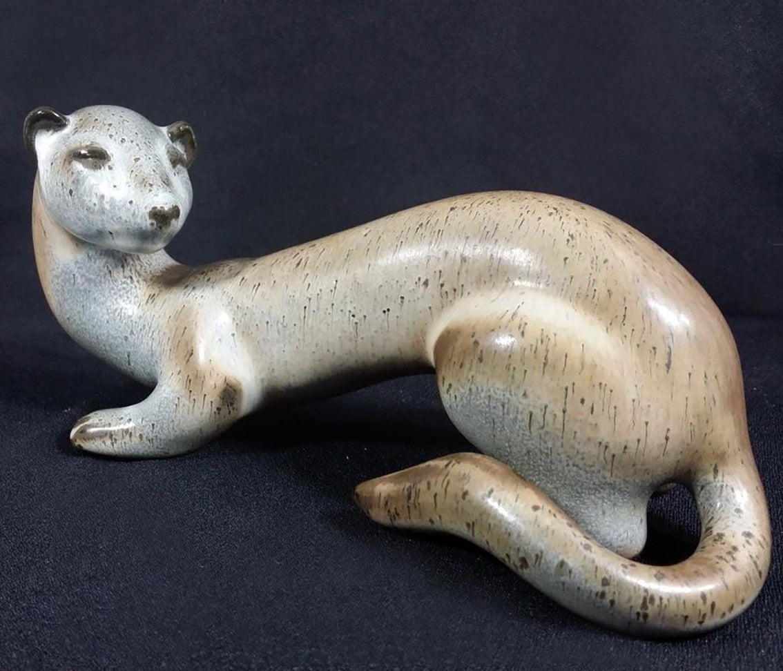 A beautiful aligned weasel in ceramic by Gunnar Nylund for Rörstrand, Sweden, circa 1960. Coloured in light grey, blue and brown with dissolved dots suggesting an alternation of coat. 
Signed GN, Röstrand, Sweden on bottom.