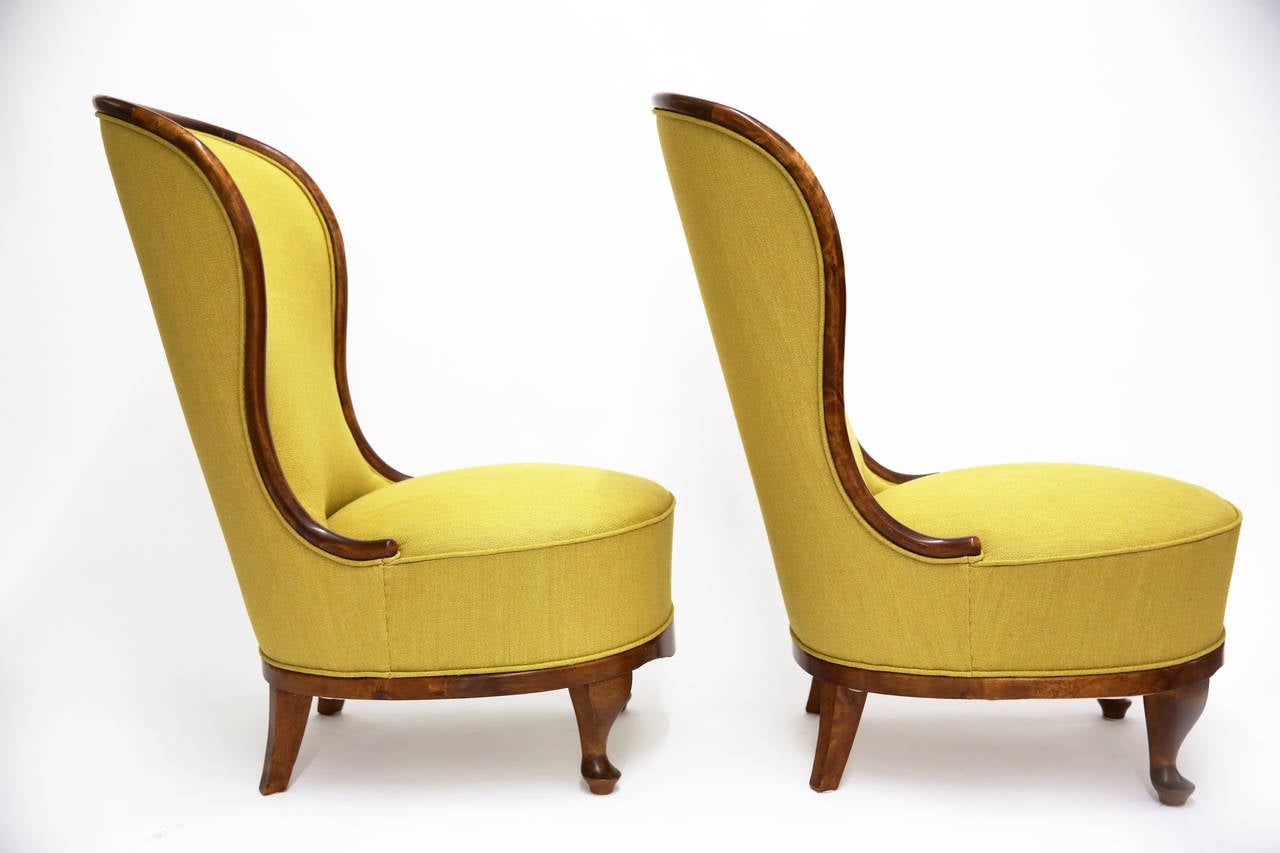 A pair of low easy chairs in elegantly curved elmwood by Tor Wolfenstein for Ditzingers in Stockholm, Sweden, early 1940s.
Newly upholstered in curcuma colored linen and cotton.