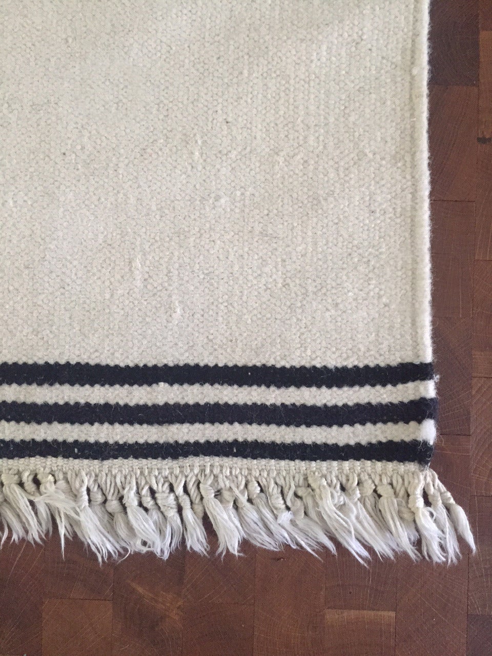 A rare flat-woven carpet by Vibeke Klint in natural snow white colored wool and black stripes. Double-sided and made by hand by Vibeke Klint in Denmark, early 1960s.