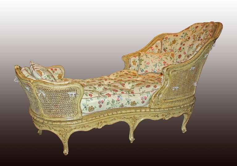 A Louis XV carved-wood and cream painted cane-work long chair.
The 