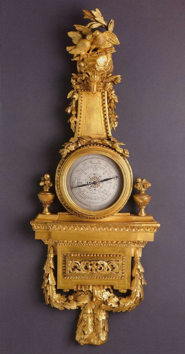 Very beautiful barometer finely sculptured and gilded. The amortization symbolizing peace is decorated with two doves walking on a quiver and a flanked head of ram of garlands of flowers.