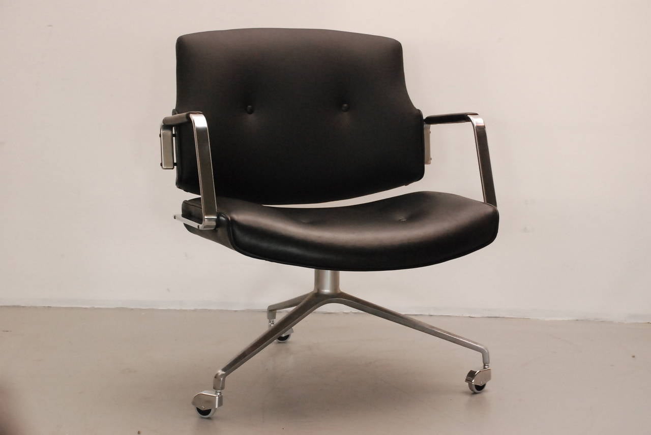 Two superb office chairs reupholstered  completely in black soft leather.
The chairs are in an impeccable condition with the original armrests.