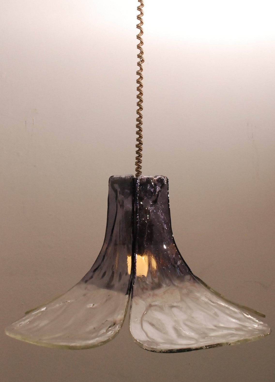 Heavy pending lamp from Mazzega with four impeccable leaves of murano glass. The height is adjustable. The lamp is in superb condition with the original wiring. Color is smoked to purple.