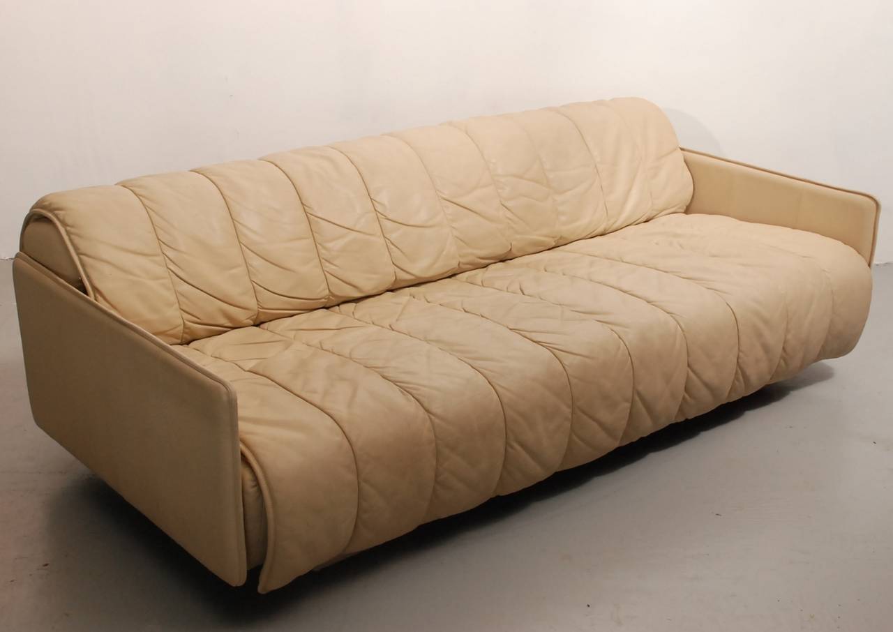 A convertible sofa bed in original black leather with stainless steel legs by De Sede of Switzerland. The front seating portion of this sofa slides away from the back panel to create a queen size bed. The seat and back upholstery are made of quilted