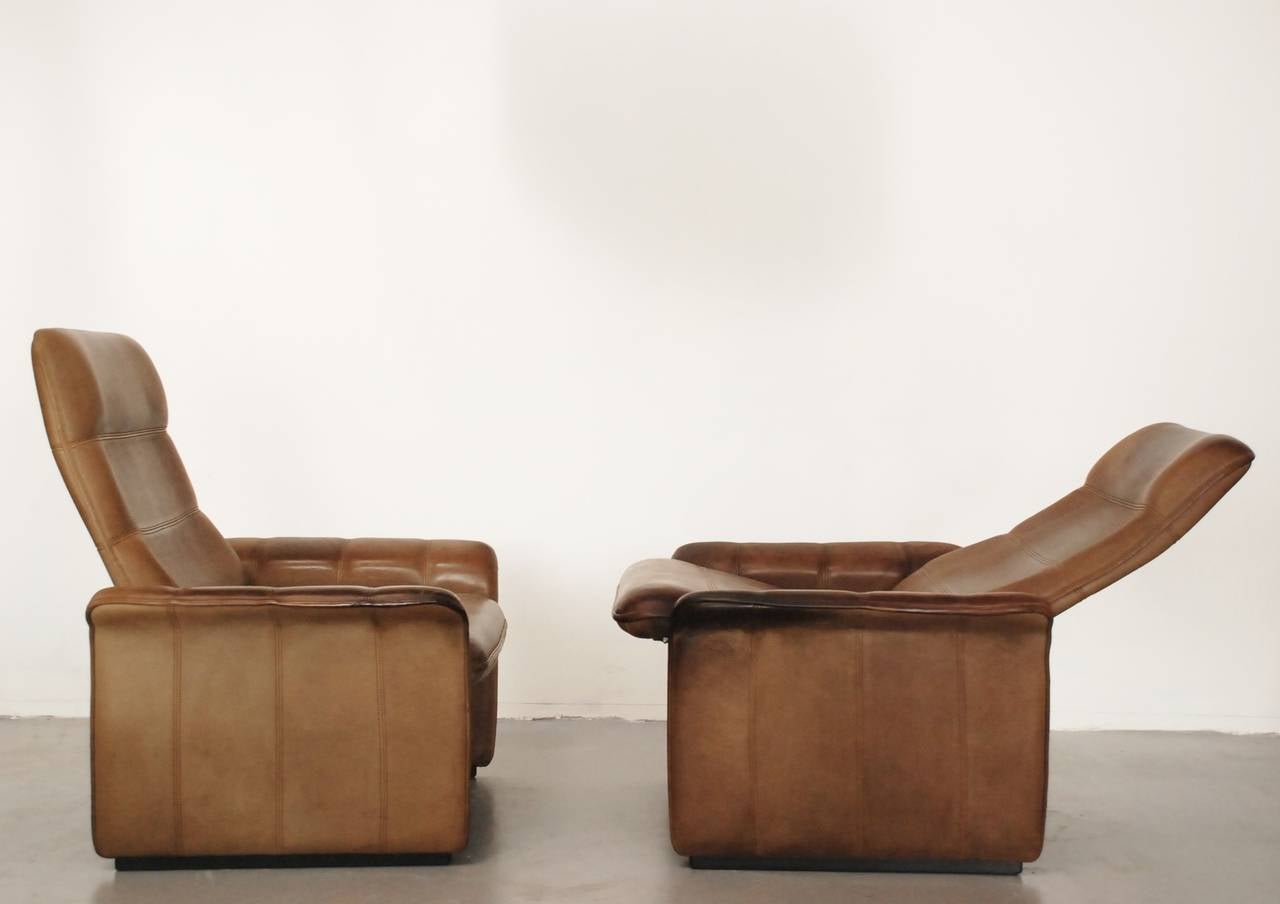 Very comfortable De Sede club chairs in their famous buffalo leather. We have two identical pieces, but one is definitely more used and has stronger patina. The price includes delivery to the US.