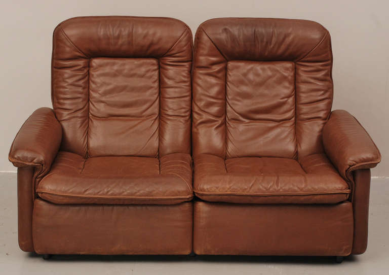 Nice two-seater from De Sede Switzerland. Made from the best materials, like a solid wooden frame and top quality leather. This couch is more than 40 years old, but still in a very good condition.  The matching lounge chair comes from the same