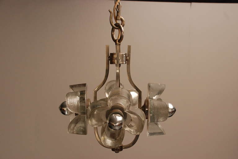 Beautiful heavy ice glass chandelier from Kalmar. Frame is made of brass.
In superb condition. We also have a 6-flower version, and two wall sconces.