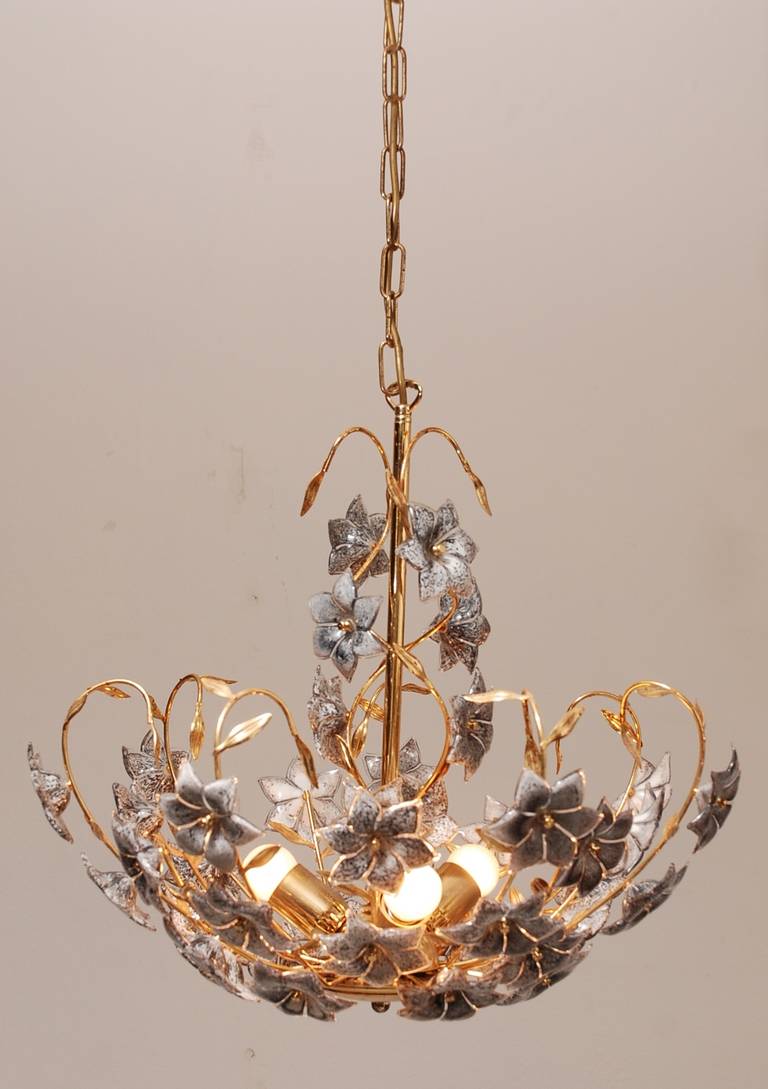 Beautiful Italian chandelier, made of brass and lots of handcrafted glass flowers. The chandelier is in a very good condition. We also have a smaller version with the same characteristics. Height of the lamp alone is 50 cm (so without the chain)