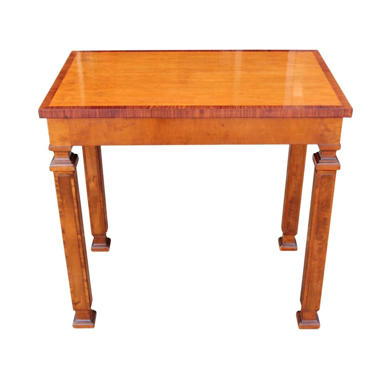 Well sized Swedish Grace rectangular console table having a top in birch with rosewood inlay banding raised on four architectural rectangular column legs with square shaped capitals and plinths and projecting corresponding fronts. In birch.