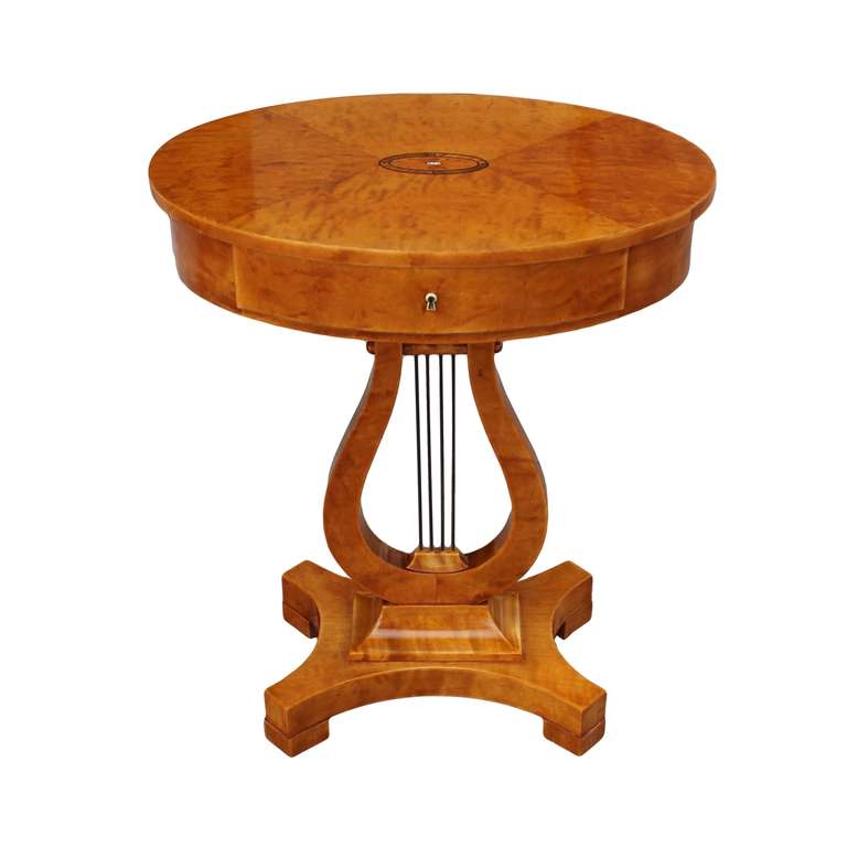 Fine side table in Karl Johan style. Oval table top with a single drawer decorated with corresponding oval shaped fan inlay in exotic wood, burnt maple, zebrano and mother of pearl. Lyre shaped pedestal with four brass strings resting on an 