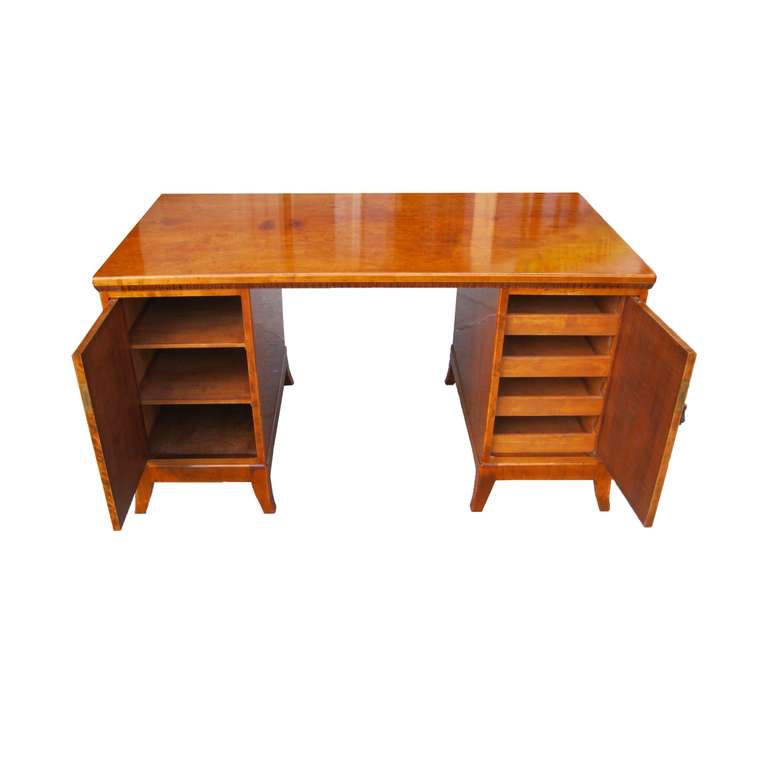 Perfectly proportioned and very well-sized desk. Top with carved and molded edge resting on a pair of cabinets: left cabinet with two shelves, right one with four very deep drawers. Doors decorated with octagonal inlays in ebony. Original bronze