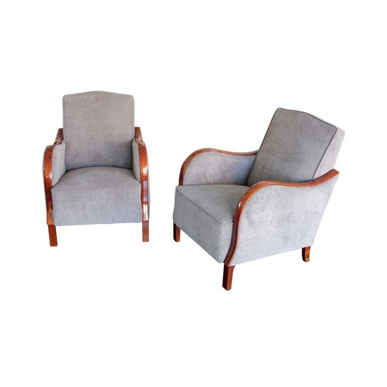 Elegant and comfortable pair of Swedish Art Deco period bergeres. Curvilinear flame birch armrests, tall arched backrest and box seat. Raised on tall and slender front block legs and and short splayed back legs.