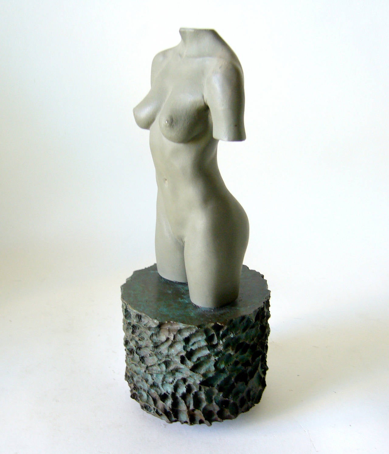 A bronze nude torso sculpture created by artist Robert Graham. Sculpture measures 11
