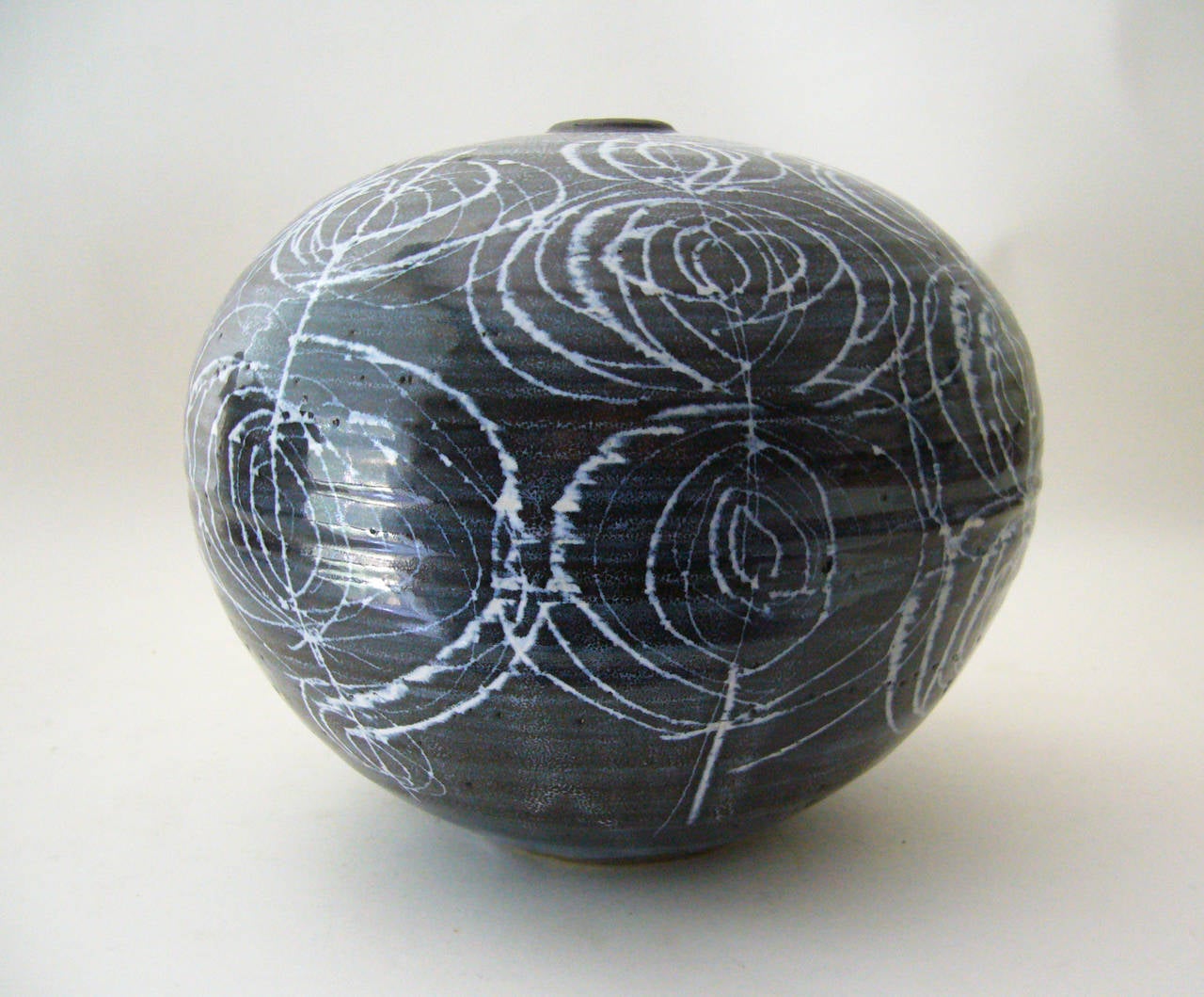 Large stoneware ceramic vase created by J.T. Abernathy of Ann Arbor, Michigan. Piece has a high contrast sgraffito glaze in black and white. Vase measures 8