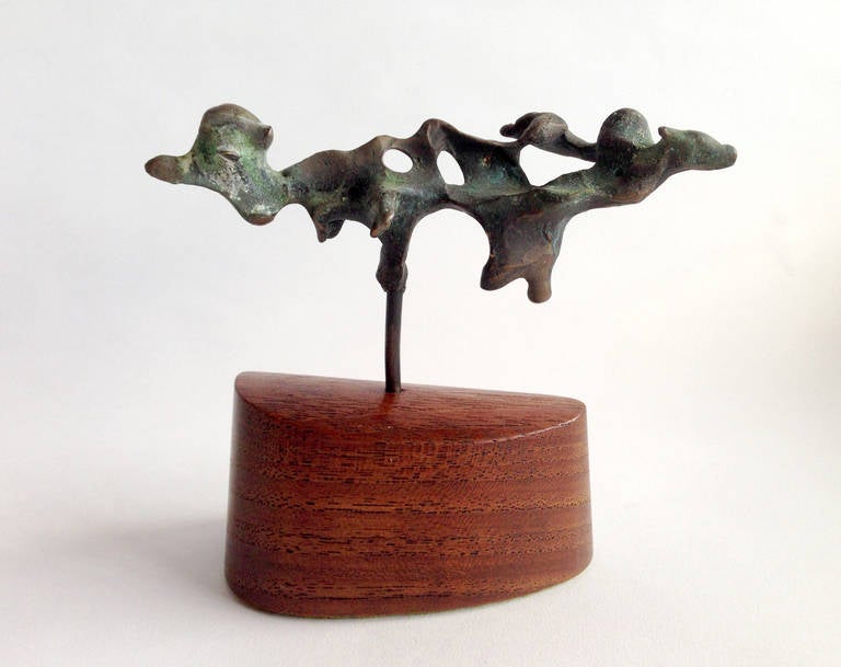 An abstract free form bronze sculture mounted on walnut base created by Jack Boyd of San Diego, California. Boyd was well respected as a member of the Allied Craftsman of San Diego.

Sculpture stands 4