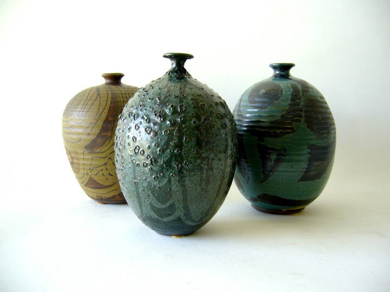 A grouping of three vases from Pottery Shack of Laguna Beach, California, circa 1960s. Two vases are signed Singleton and one is signed Rose. Ranging in height from 6.5