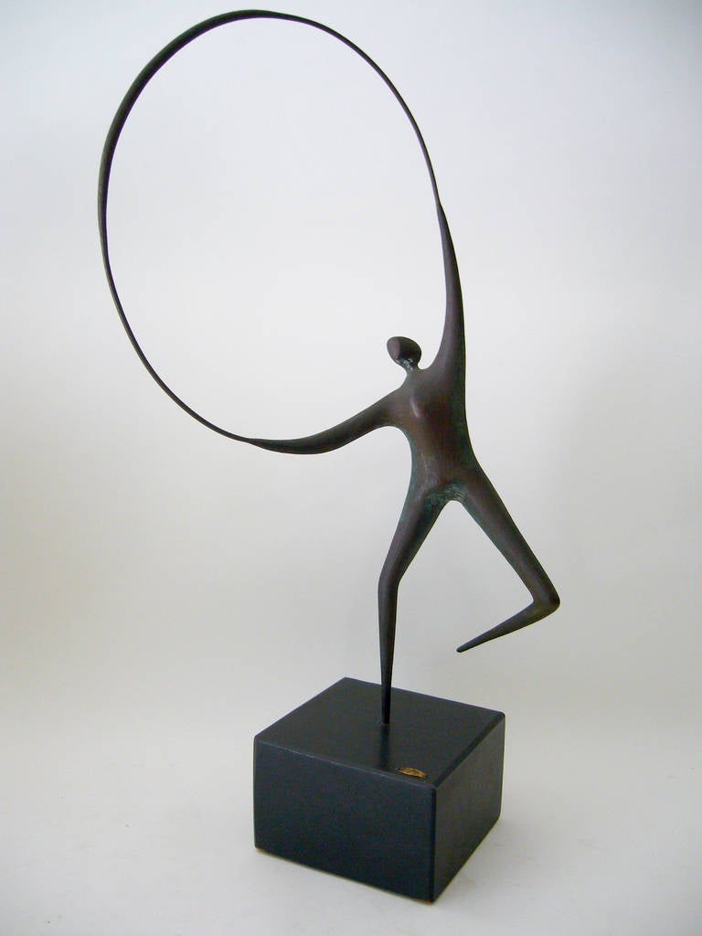 A metal jump rope figure with bronze finish by Curtis Jere, circa 1968. Sculpture is a derivative of Jack Boyd's figurative bronzes. It measures 22