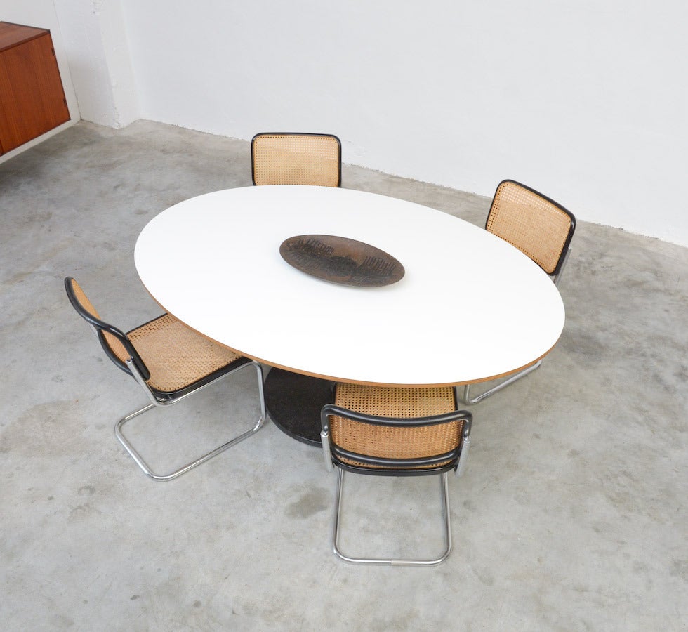 This great elliptical dining table was designed by Alfred Hendrickx in the 1960s. This one was bought in 1969.
The base is made of black marble and inox. The elliptical white top is made of smooth formica on multiplex.
This minimal dining table is