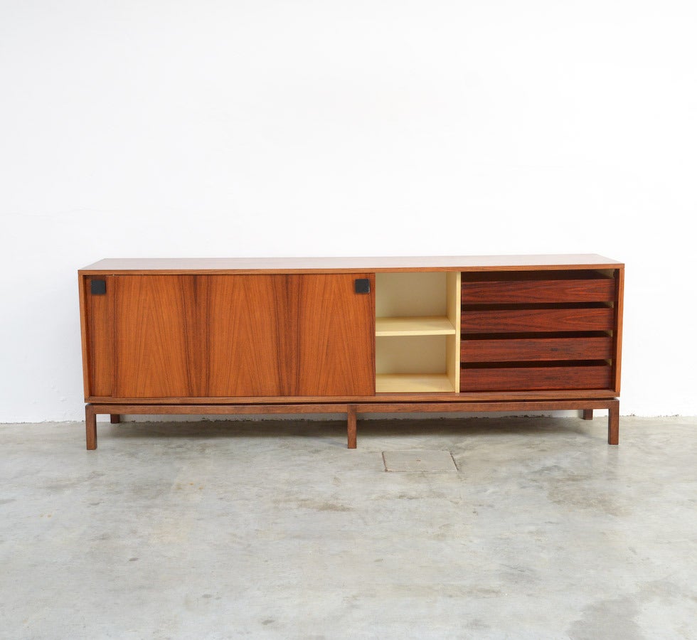 This extraordinary sideboard is a design of Alfred Hendrickx for Belform in the 1960s.
It is a minimal and pure piece of furniture made of high quality materials. The design of the wood veneer on the 2 sliding doors is amazing and creates on the