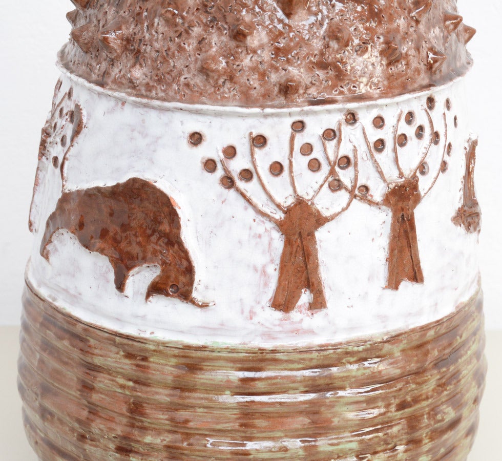 This very impressive ceramic vase is made in the 1960s. It is not marked, so we don’t know the designer or the workshop.
Nevertheless this vase has a special shape and the bucolic landscape in bas-relief, in white and brown is touchable.
This huge