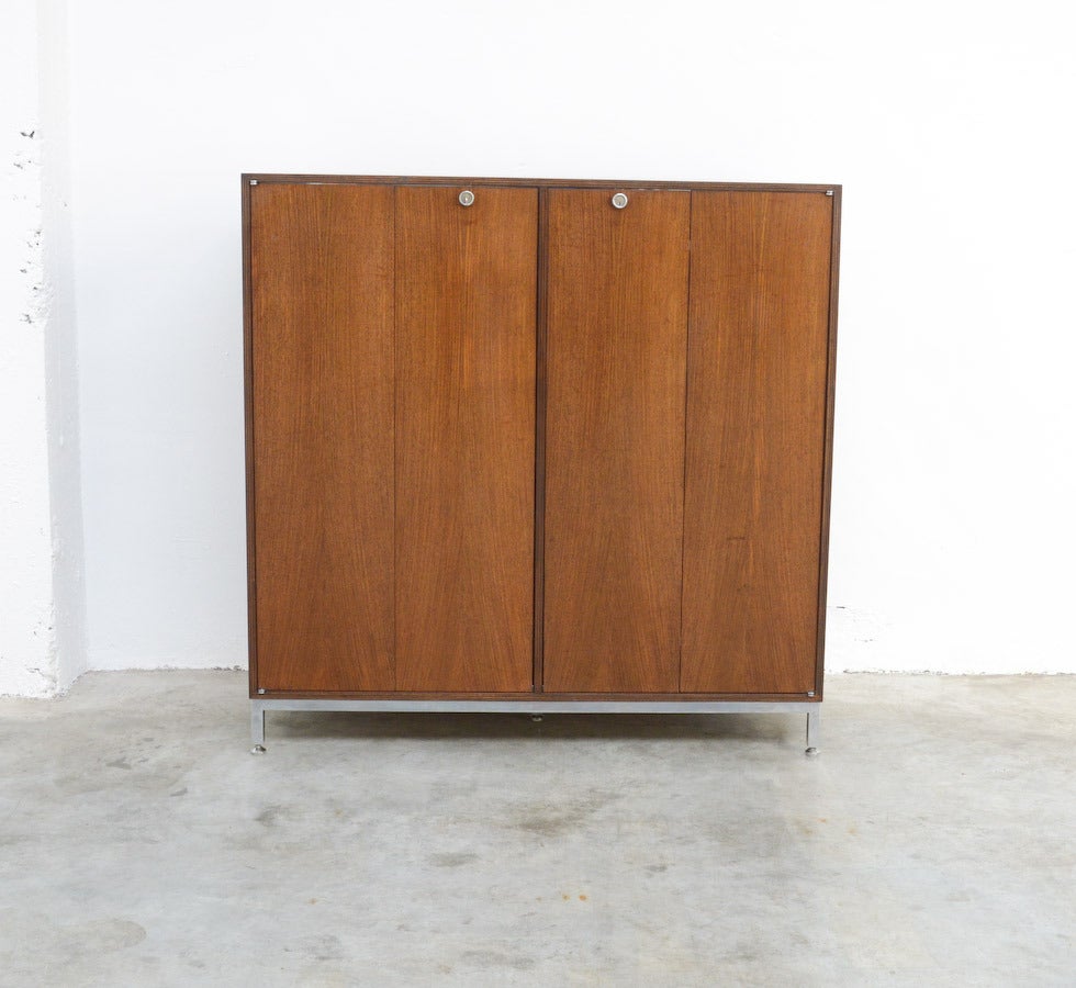 This minimal rosewood cabinet was designed by Jules Wabbes around 1960 for Bergwood.
It is a nice and practical design. The “butterfly” doors are beautiful, the back side is also finished, so this cabinet can be used as room divider. The detailed